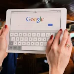 Google search on laptop screen desk setup