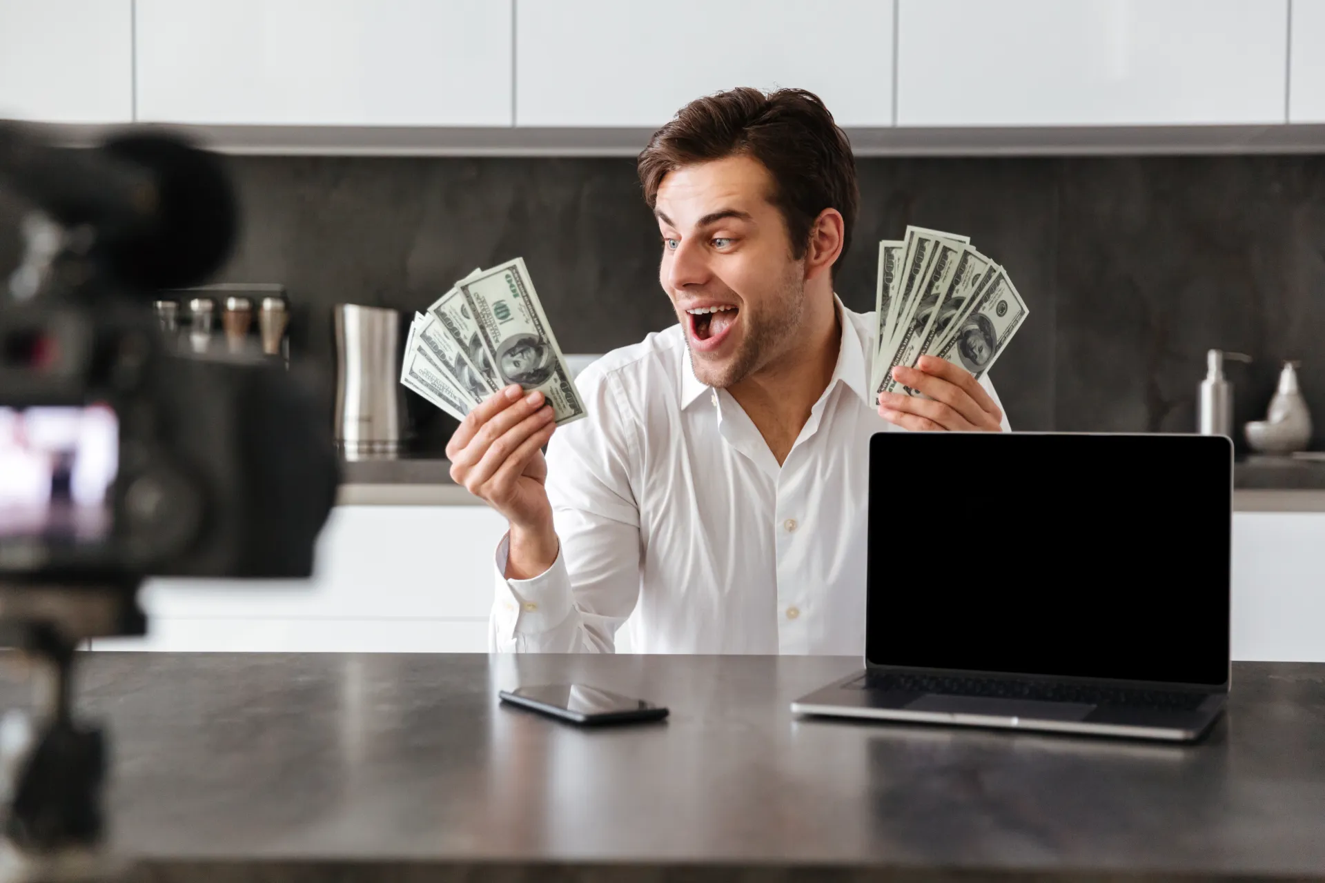 Person using laptop with money success concept representing online earning in 2026