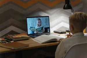 Students using laptops in a modern classroom for digital learning and online education