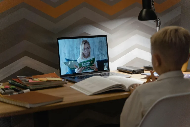 Students using laptops in a modern classroom for digital learning and online education
