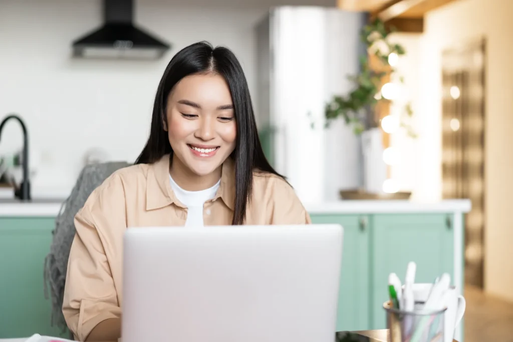 Woman working on laptop from home earning money through online jobs