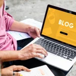 A laptop on a desk used for writing a blog
