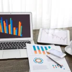 Blogging workspace with laptop, growth chart, and online income concept for beginners in 2026